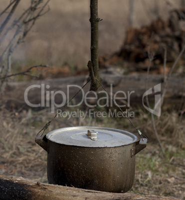 Cooking in old sooty cauldron on campfire