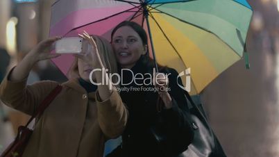 Two girls makes selfie on rainy day