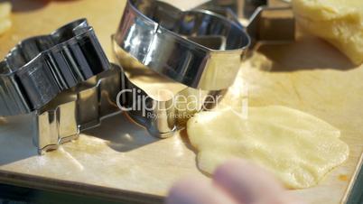 Woman's hands make molds for pastry dough