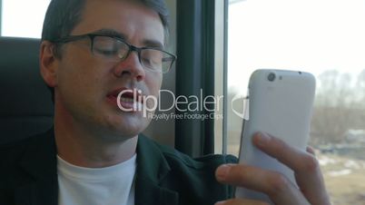 Businessman talks on skype using smartphone