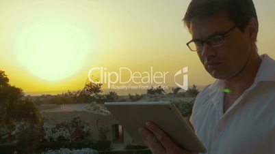 Businessman using touch pad in the evening