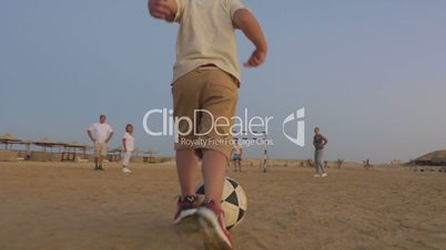 Boy is ready to make a goal in this beach football