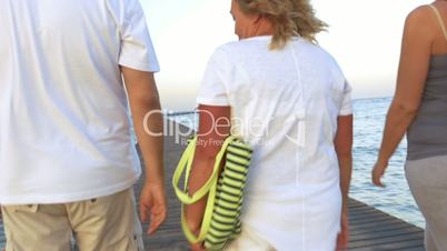 Family with shopping bags walking on the pier