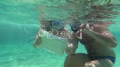 Young Couple Making Selfie Underwater