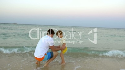 Father and son having fun in surf