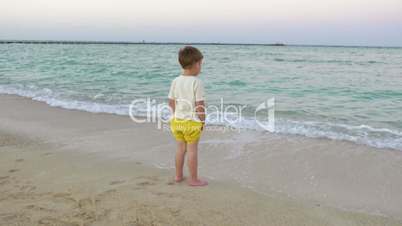 Boy Standing in the Incoming Waves