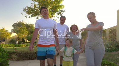 Family walk outdoor on summer resort