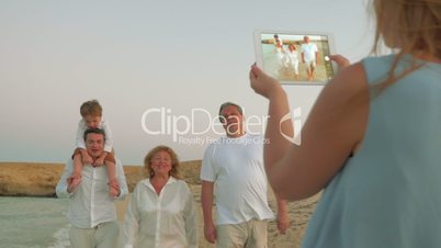 Using pad to take shots of family on vacation