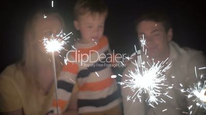 Son and His Parents Catching Sparkles of a Bengale Fire