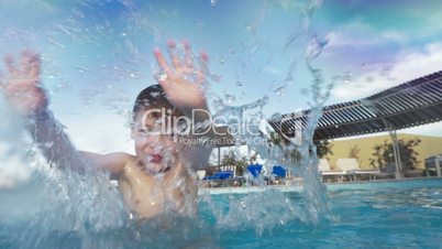 Boy having fun in the pool on resort