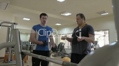 Gym instructor giving consultation to a man