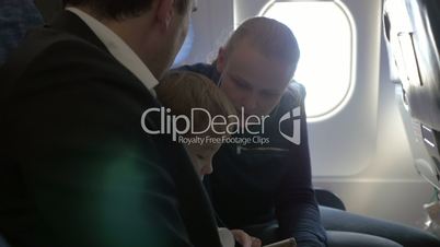 Child and young parents traveling by plane