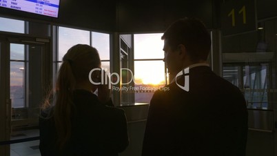 Young people at the airport at sunset
