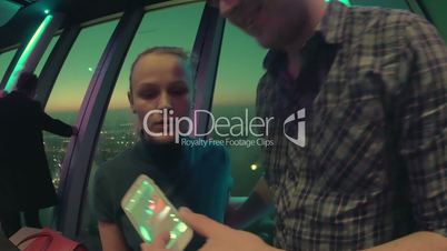 Loving couple making selfie with cell at sky deck