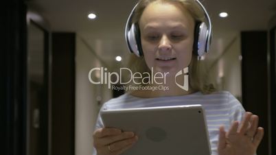 Timelapse of girl listening to music with tablet PC