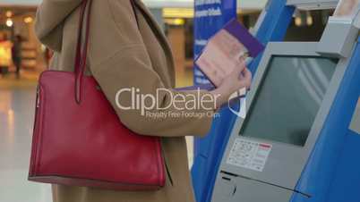 Woman doing self-check in at the airport