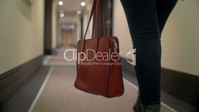 Woman with bag walking in hotel hall