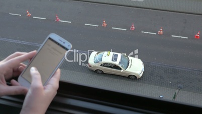 Woman coming to the balcony and using smart phone