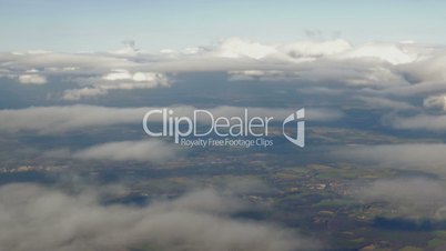 Aerial view to city through the clouds