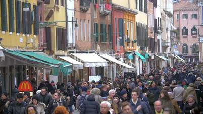 Tourists and citizens in busy Venetian street