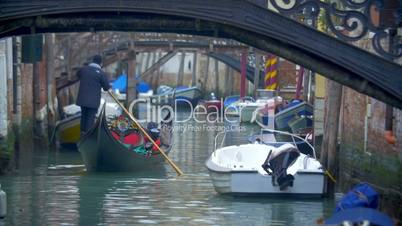 Gondola Sailing Along the Water Canal in Venice, Italy