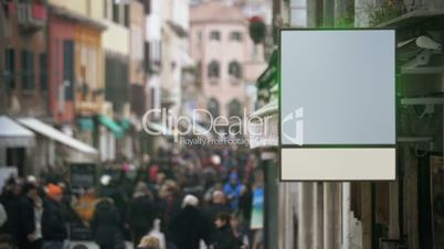 Blank banner hanging in crowded street