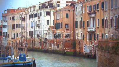 Venice cityscape with old style houses and still canal