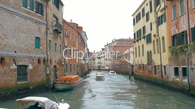 Motor boats sailing on canal in Venice