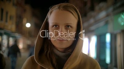 Woman in coat and cowl walking outdoor