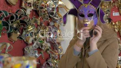 Woman in the store of Venetian masks
