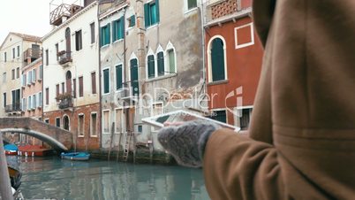 Girl using tablet PC during the walk in Venice