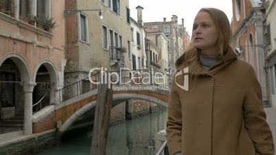 Woman having coffee while walking in Venice