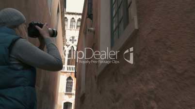 Tourist or professional photographer shooting in Venice