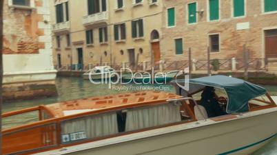 Touristic boats sailing on canal of Venice