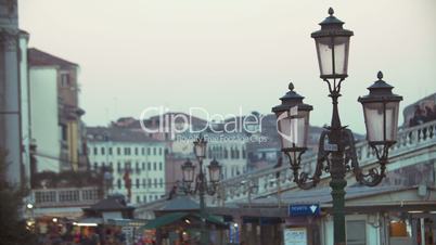 Venice scene with people on the bridge and street lantern