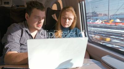 Young people on business travel with laptop