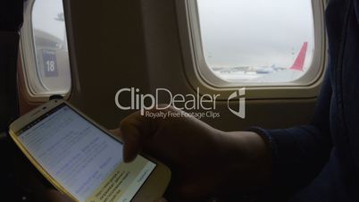 Online hotel search on phone in plane