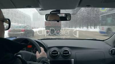 Timelapse of senior traveler driving in winter city