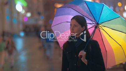 Two women friends meeting in rainy evening