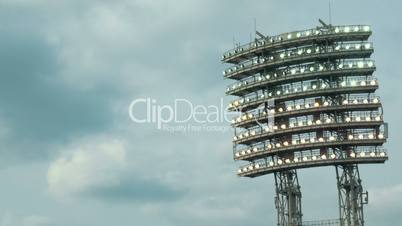 Stadium lights against cloudy sky background