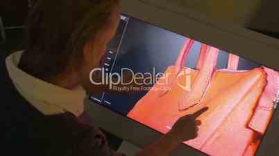Woman Viewing 3D Model of a Bag on Big Touch Screen