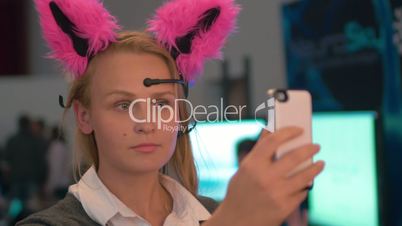Woman with neuro ears making selfie