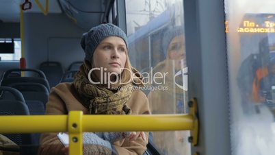 Woman passenger looking out bus window