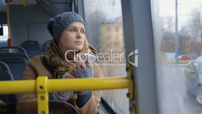 Woman with Smartphone Riding a Bus