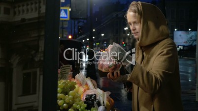 Woman buying fruit in outdoor market