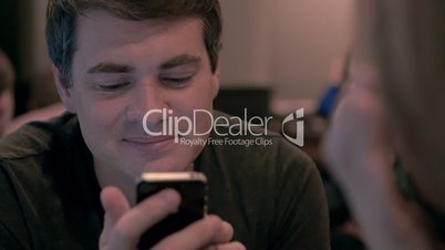 Young man using cell phone with happy look