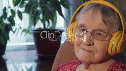 Senior Woman Listening to the Music in Headphones