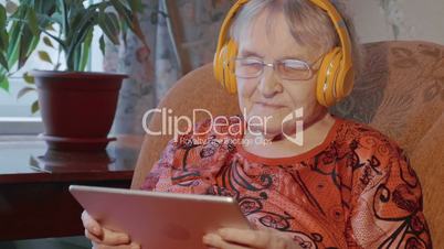 Grandmother using touch pad in wireless headphones