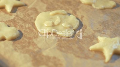 Woman hand placing cookie dough on baking tray