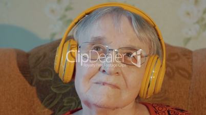 Elderly woman listening to music in headphones